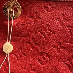 I’m selling a beautiful red Louis Vutton authentic bag and wallet